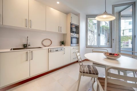 Kitchen: Bright and functional space with modern appliances and lush garden views!