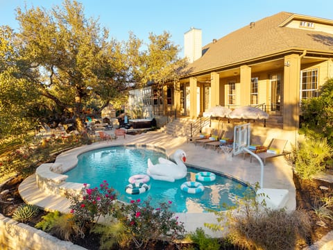 Pool with pool loungers, hot tub, outdoor dining patio, and covered patio. **Pool is NOT heated.