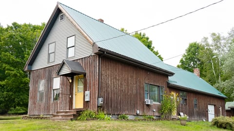 The main entrance with keypad faces the driveway. The two bedrooms are on the street side of the house, and the living room and kitchen picture windows face East with a view of the horse pasture and historic rock wall.