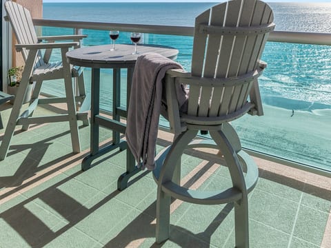Oceanfront balcony with high-top seating and stunning turquoise views