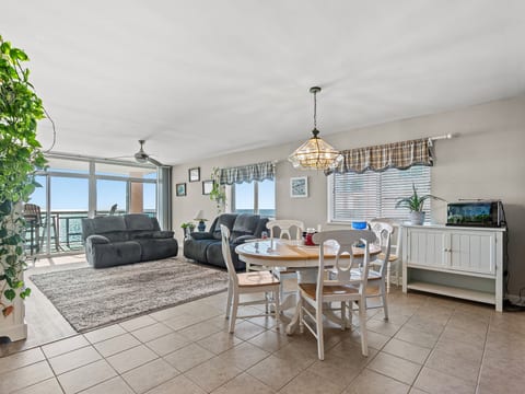 Bright coastal living space with ocean views and balcony access