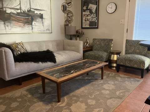 Remodeled North Park bungalow living room with plush seating and nautical art