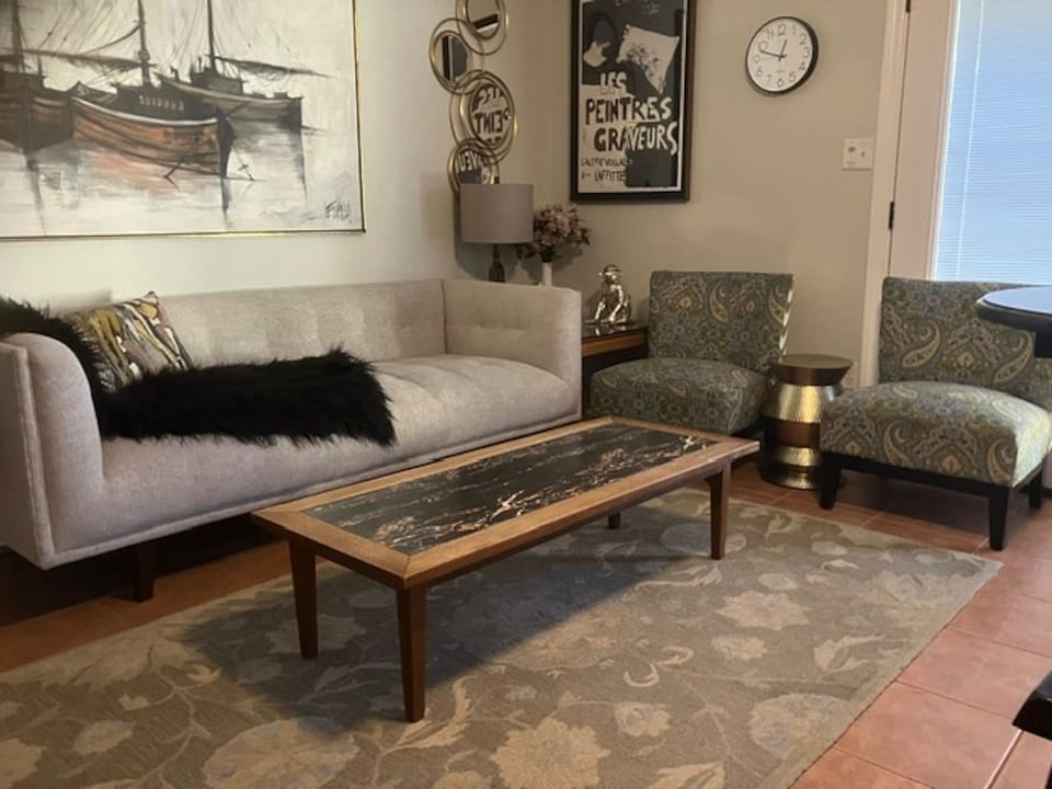 Remodeled North Park bungalow living room with plush seating and nautical art
