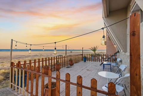 Beachfront patio with sunset views and cozy string lights