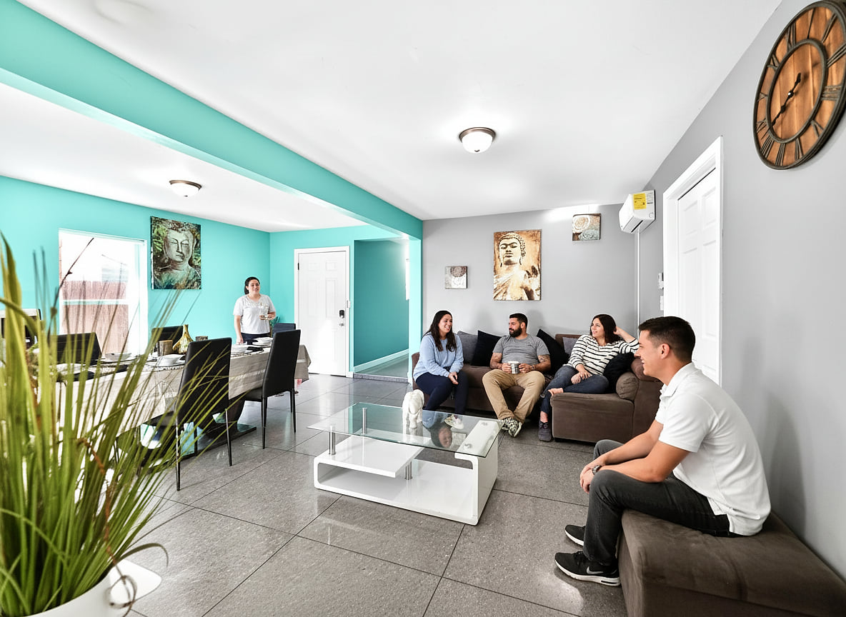Sunny open-plan lounge with AC, ample seating, dining area & modern decor