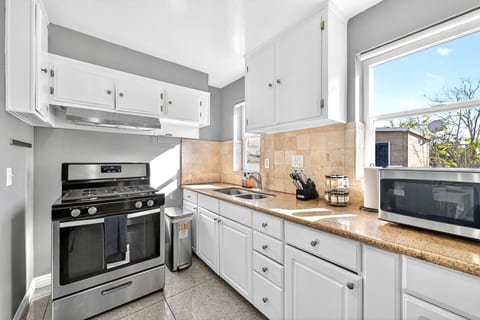 Bright kitchen with gas range, granite counters, and ample storage