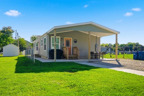 Front of the property with plenty of parking for multiple vehicles, outdoor seating area and grill