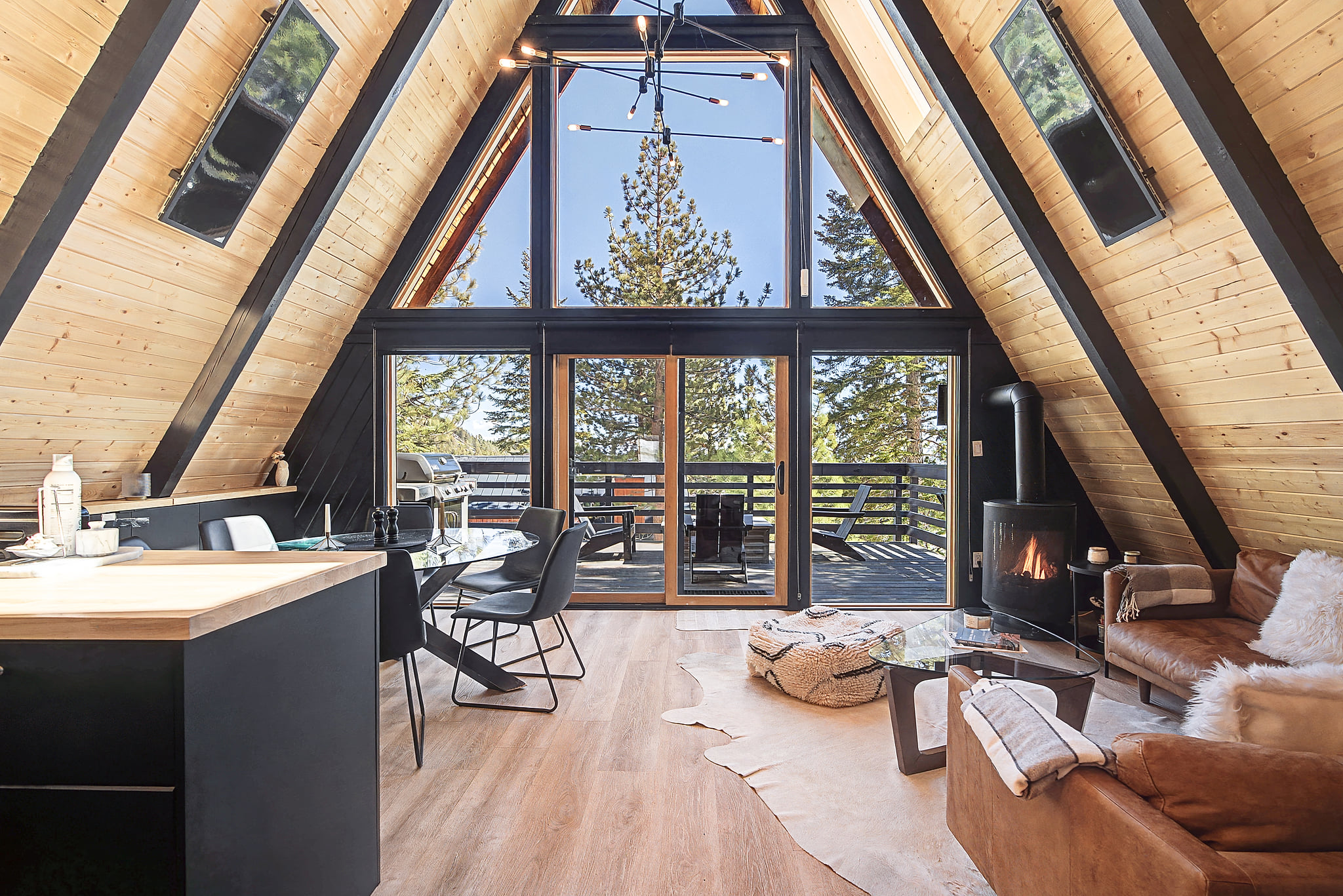 Modern A-frame retreat with forest views, sunny deck, and a crackling fireplace