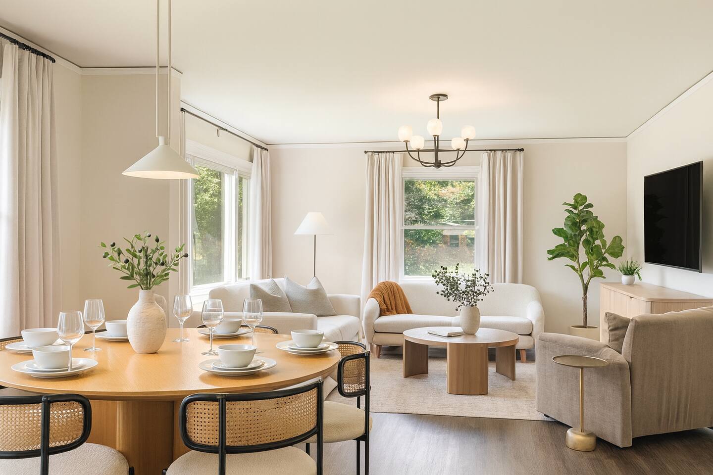 Stylish open-concept dining and living area with natural light—perfect for enjoying your meals and relaxing in comfort.