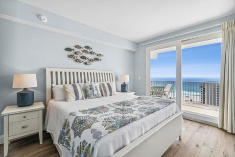 Relax in the serene primary bedroom featuring a king bed and panoramic ocean views