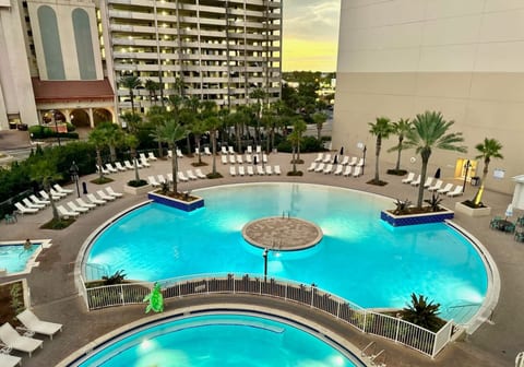 Beautiful evening view of the lagoon pool with ample lounge chairs and tropical landscaping