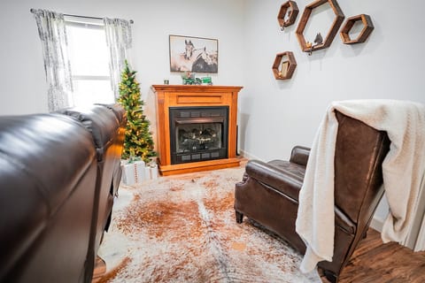 Cozy reading space with gas fireplace and cowhide rug, chair reclines for ultimate relaxation