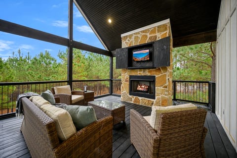 Covered deck lounging with a fireplace 🔥