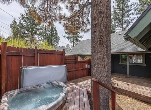 Private fenced hot tub deck beneath the pines for a cozy mountain soak