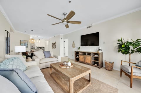 Open-concept dining and living space with natural light, modern coastal decor, and room to gather comfortably.