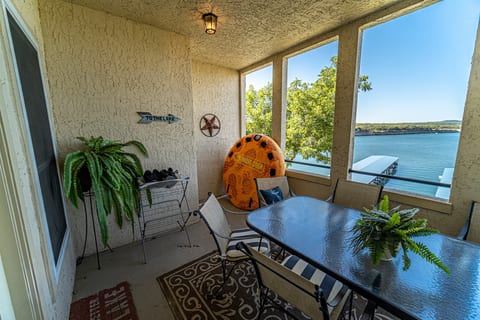Private covered patio with dining table, lake views, and a relaxing indoor-outdoor feel