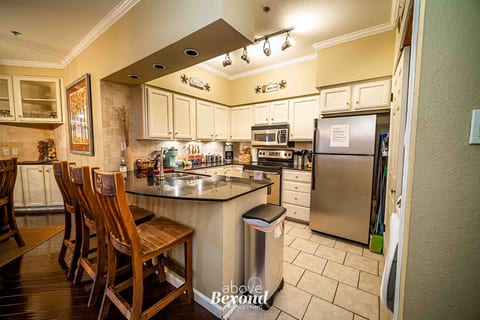 Fully equipped kitchen with breakfast bar and dining space, ideal for family meals and extended stays.