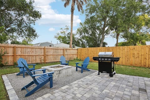 Outdoor firepit with 4 Adirondack chairs, BBQ grill, and outdoor picnic table