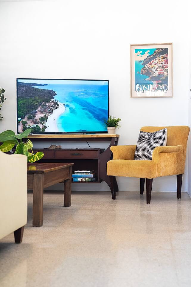 Bright cozy corner with smart TV and a comfy chair for relaxing moments