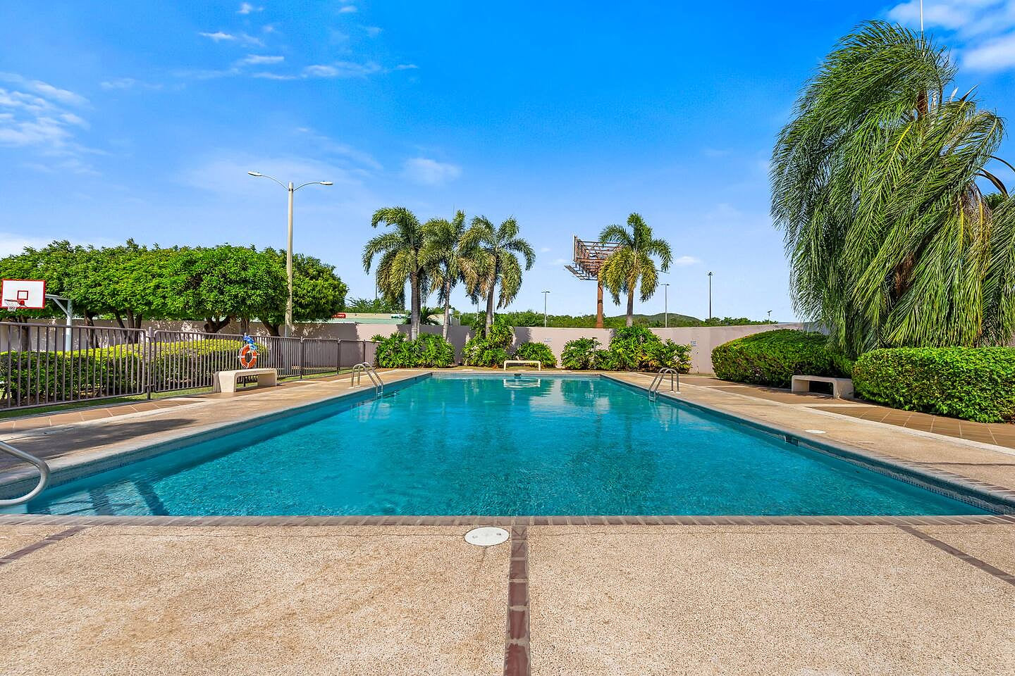 Relax by the sparkling pool under sunny Caribbean skies.
