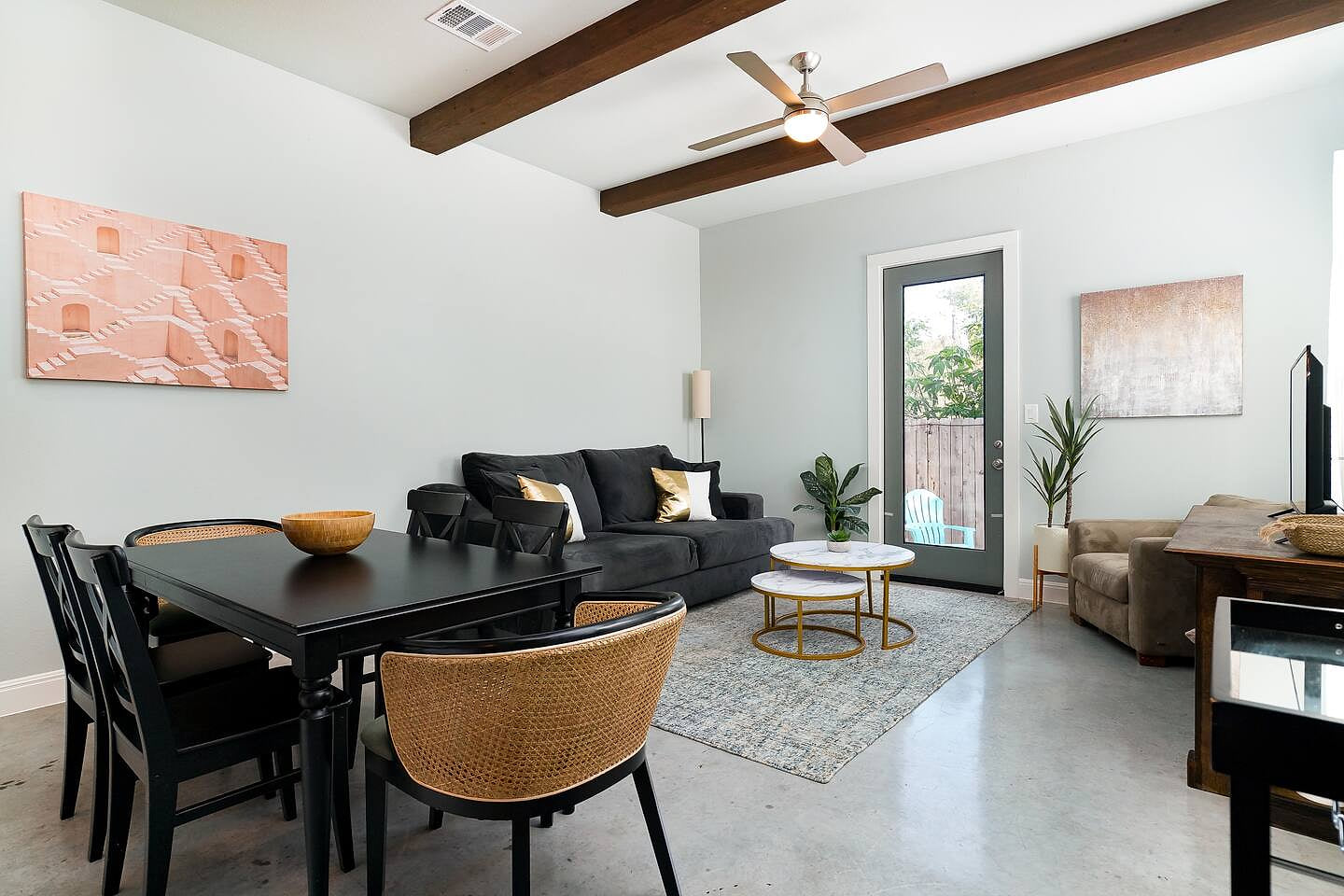 Bright and stylish living space with exposed beams, cozy seating, and a modern dining area. Perfect for unwinding after exploring downtown,  just minutes from the Alamodome, the River Walk, and San Antonio’s top attractions.