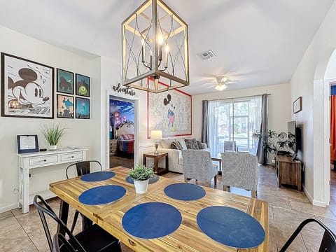 Enjoy an expansive dining room that flows into a Mickey Themed living room.