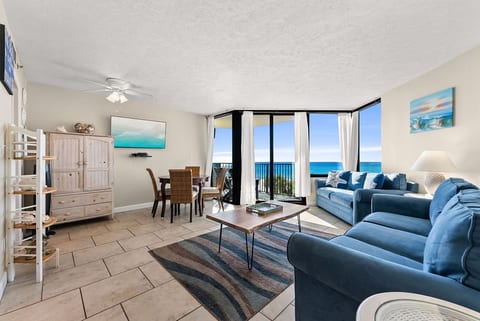 Open living and dining area with direct balcony access and beach views.