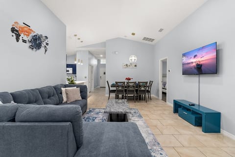 Bright, comfortable living room with plenty of seating and a Smart TV - perfect for relaxing after theme park days.