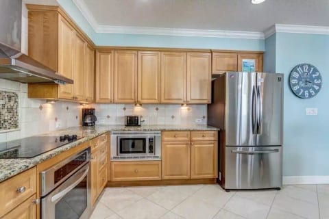 Kitchen with granite countertops and stainless appliances 
