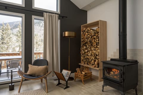 Your dedicated corner for quiet reflection. Sink into the lounge chair with a fresh cup of coffee and enjoy the warmth of the wood-burning stove.