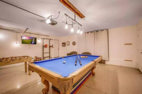 Entertainment/ Exercise room with Billiard Table, foosball table, pull up bar and water rower machine