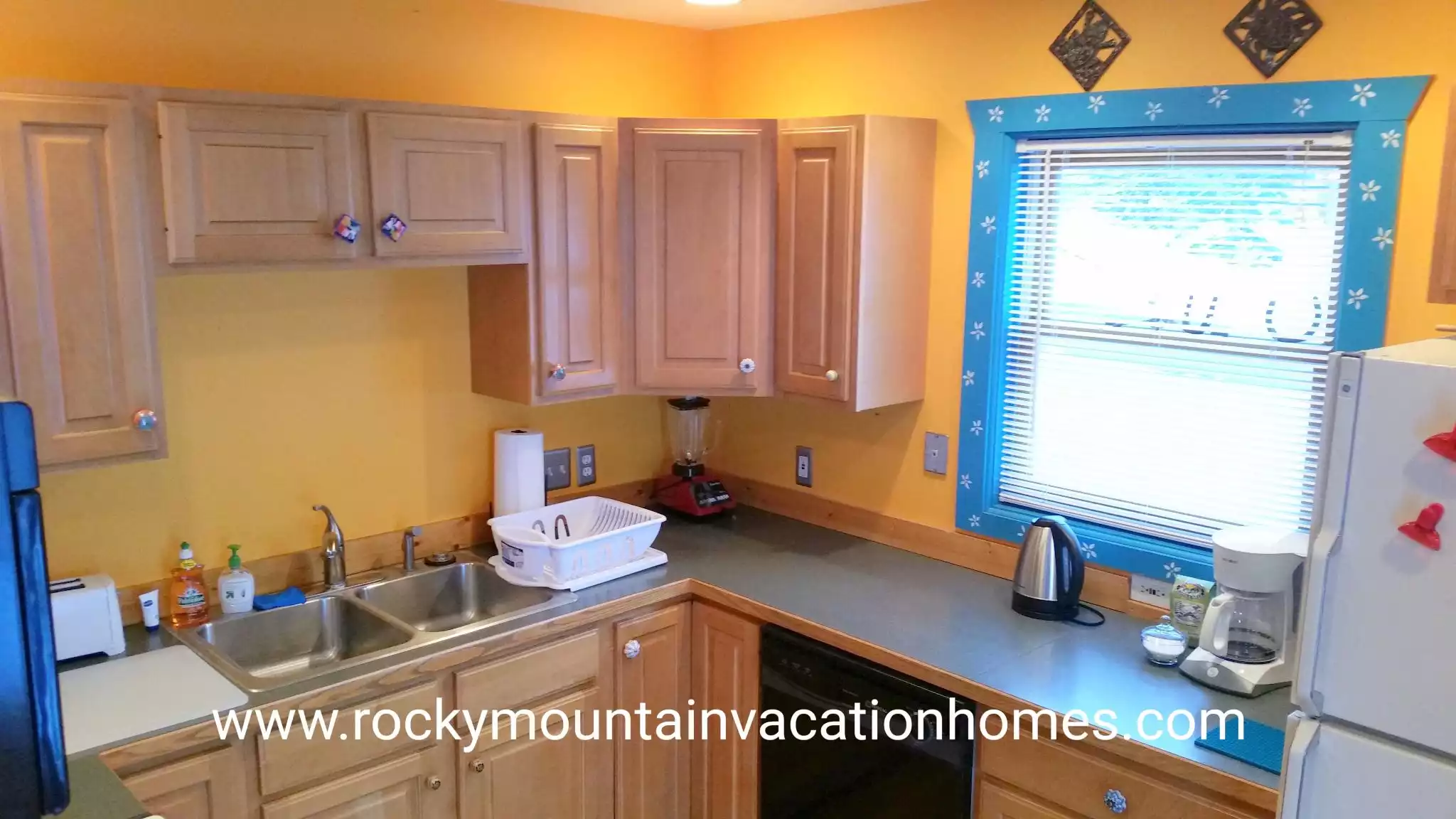 Kitchen has coffeemaker, toaster, kettle, blender, and utensils