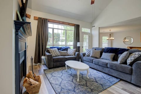 Relax and create memories in the tall-ceilinged living room that overlooks the beauty of the backyard