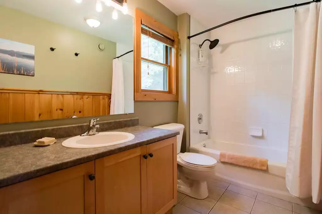 The first floor full bath features a rainfall shower head and a spacious tub for the little ones! The first floor full bath features a rainfall shower head and a spacious tub for the little ones! - MOUNTAIN SKI CHALET | INCREDIBLE CATSKILLS VIEWS - Prattsville