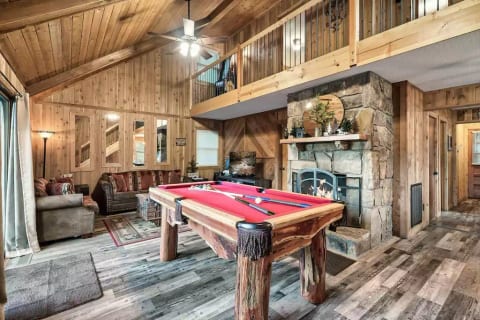 Welcome to our cozy cabin! The modern rustic interior will make you feel right at home in the mountains. Refine your pool skills while hanging out in the living area.