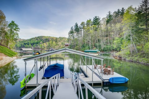 Private dock with dining table & 4 chairs, 2 lounge seats, a swim ladder, 3 kayaks, a paddle boat and paddleboard for guest use