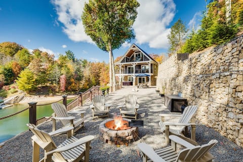 Fall at Skipping Stones Getaway Backyard with hot tub, fire pit, wood, roasting forks, corn hole boards, picnic table
