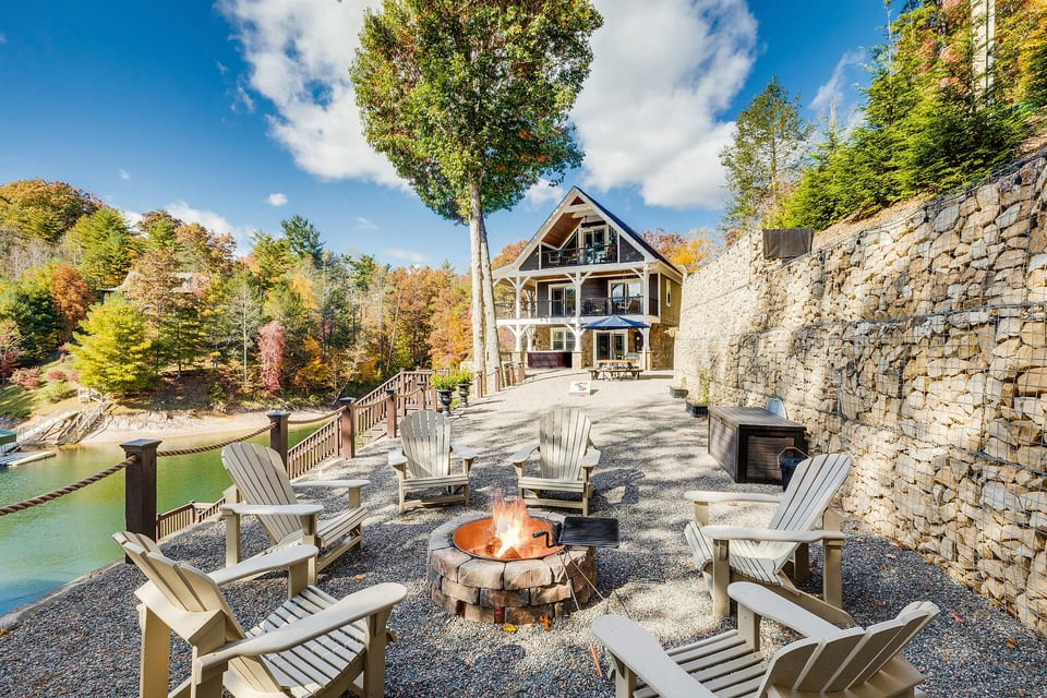 Fall at Skipping Stones Getaway Backyard with hot tub, fire pit, wood, roasting forks, corn hole boards, picnic table