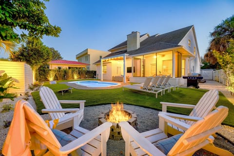 Evenings by the fire, pool lights glowing, and the perfect backyard setup for long conversations under the stars.