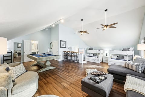 Expansive upstairs retreat with pool table, lounge seating, and bonus bunk space.