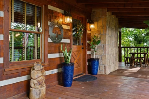 Rustic log accents and a handcrafted welcome sign greet you at the door — the charm of Nestled Oaks starts before you even step inside.