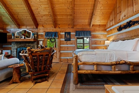 Handcrafted log furniture and warm wood walls set a romantic, rustic tone at Nestled Oaks.