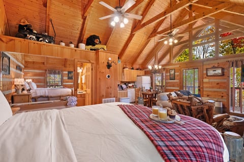Wake up to fall color through the windows. Vaulted beams, plaid blankets, and a queen bed made for chilly mountain mornings.