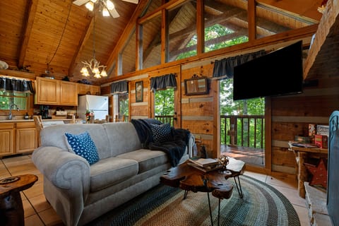 Sink into the plush sofa and let the mountain quiet take over in the cozy living room at Nestled Oaks.