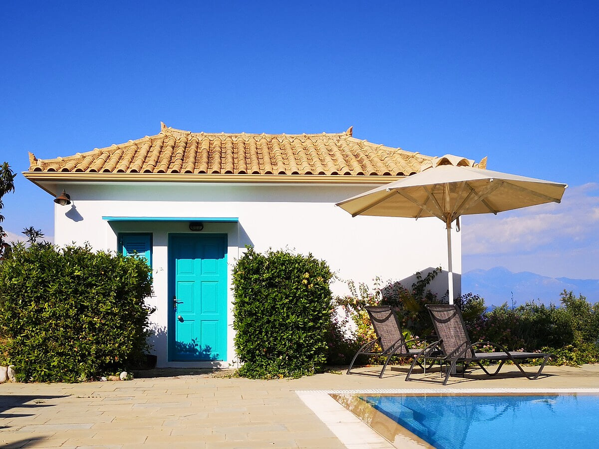 This villa’s entrance opens onto the pool area, with a private balcony at the back overlooking the sea and our peaceful vineyard — the best of both worlds.