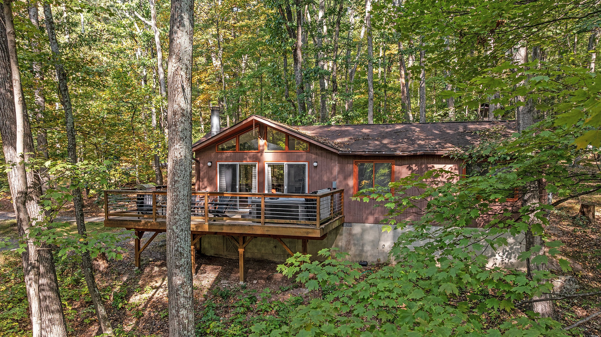 Unwind in the hot tub or take in the view from the deck — serene woods surround this charming Berkeley Springs chalet