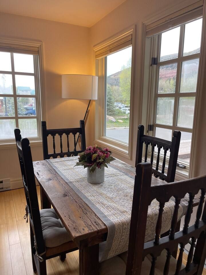 Dining table located in living room area with beautiful view of mountains.