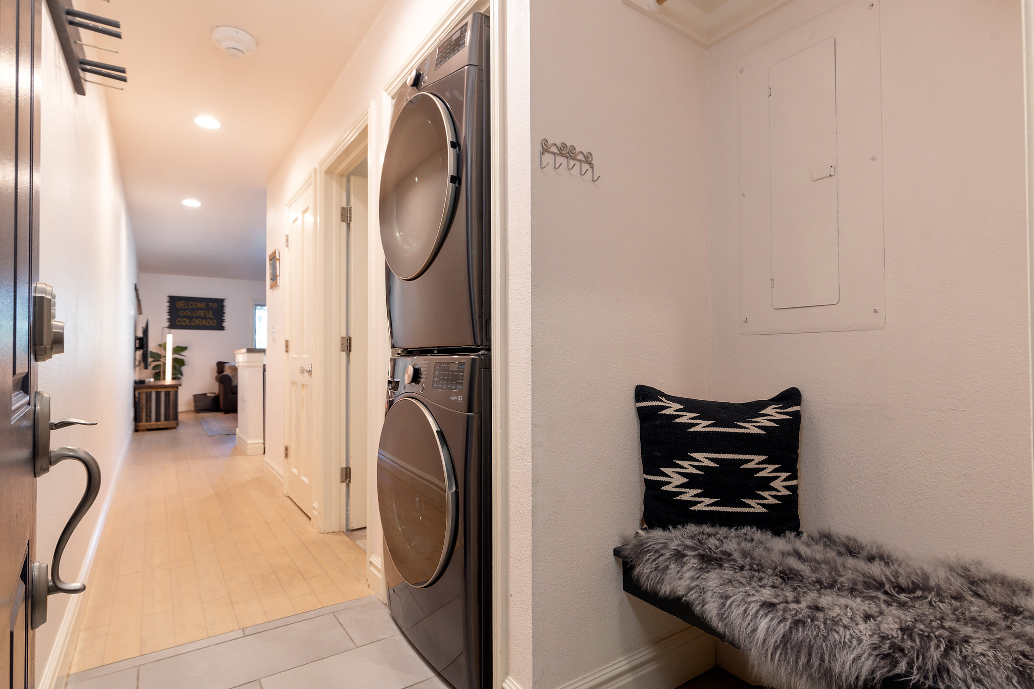 Bright entry hall with cozy bench and convenient in-unit laundry