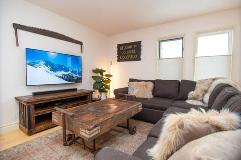 Plush comfy lounger in living room with 65" smart tv, Bose surround sound system and queen sized pullout couch bed.