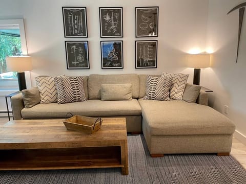 Spacious inviting living room filled with natural light. Open the windows and hear the creek rushing by.